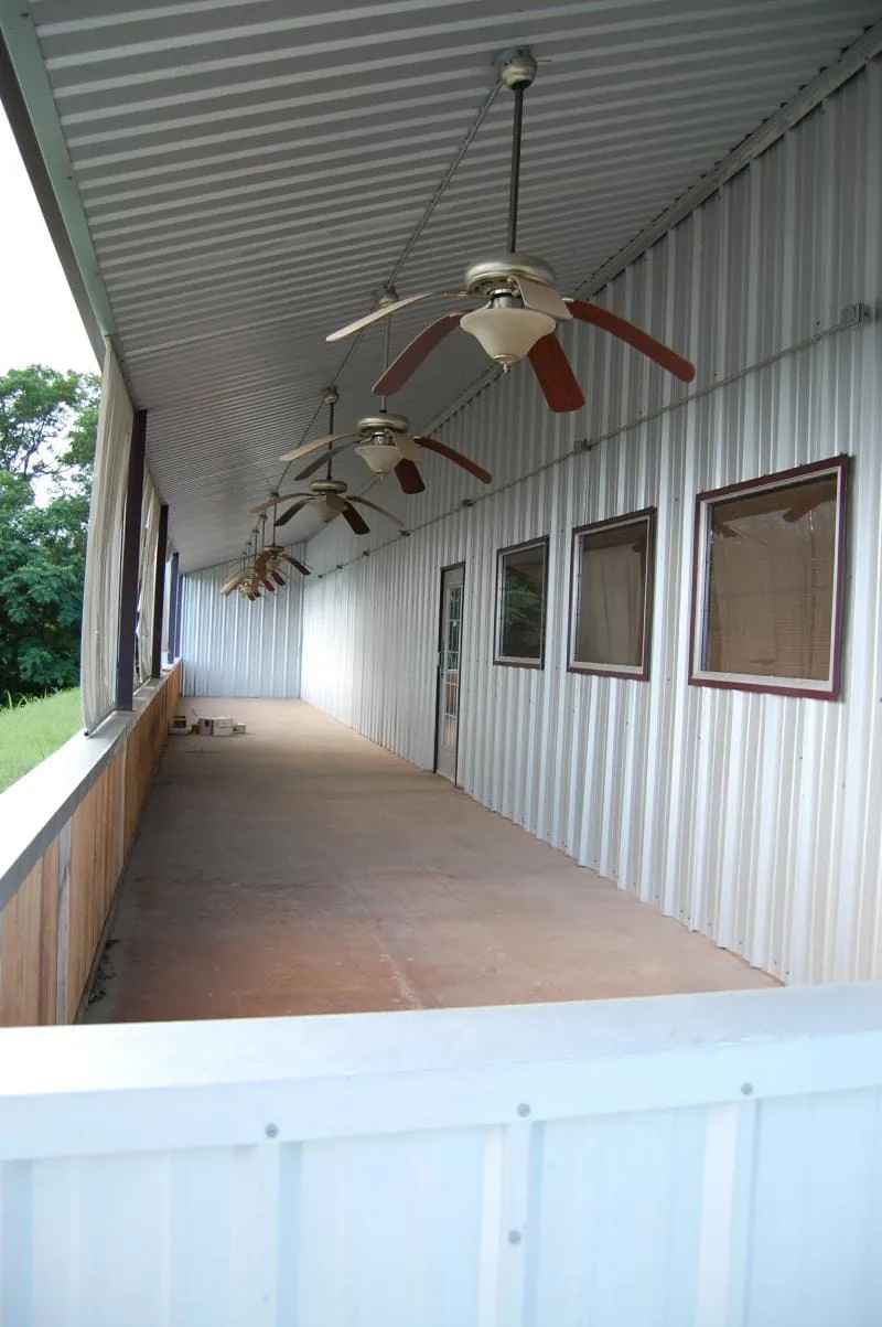 Covered side porch with ceiling fans at the restaurant building.