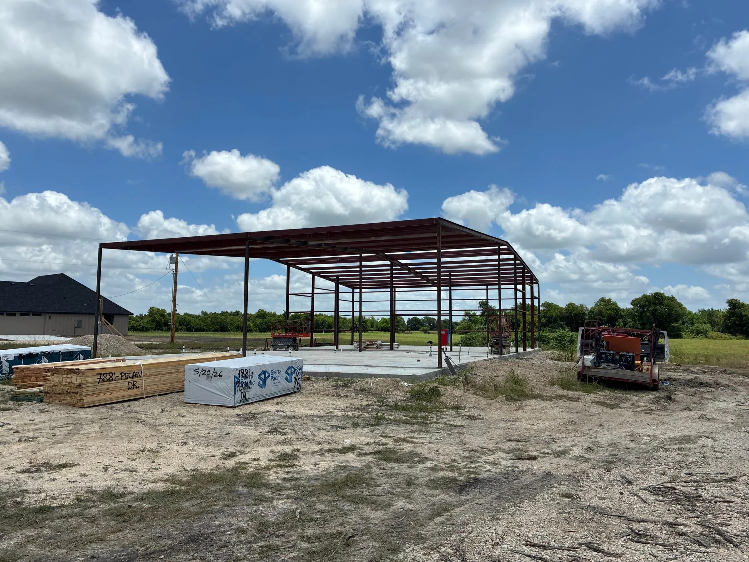 First steel bays standing on the large concrete foundation.