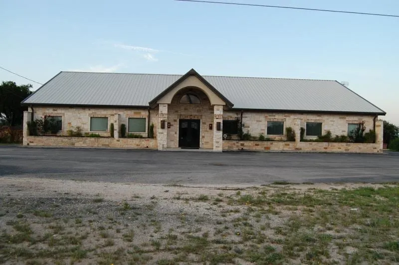 Professional office building with stone entry and metal roof.